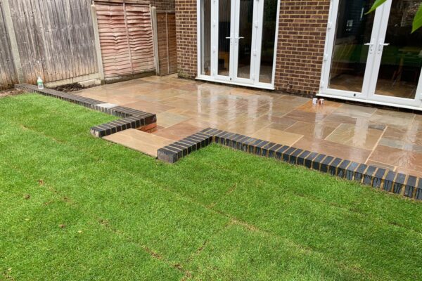 sandstone patio laid with new lawn